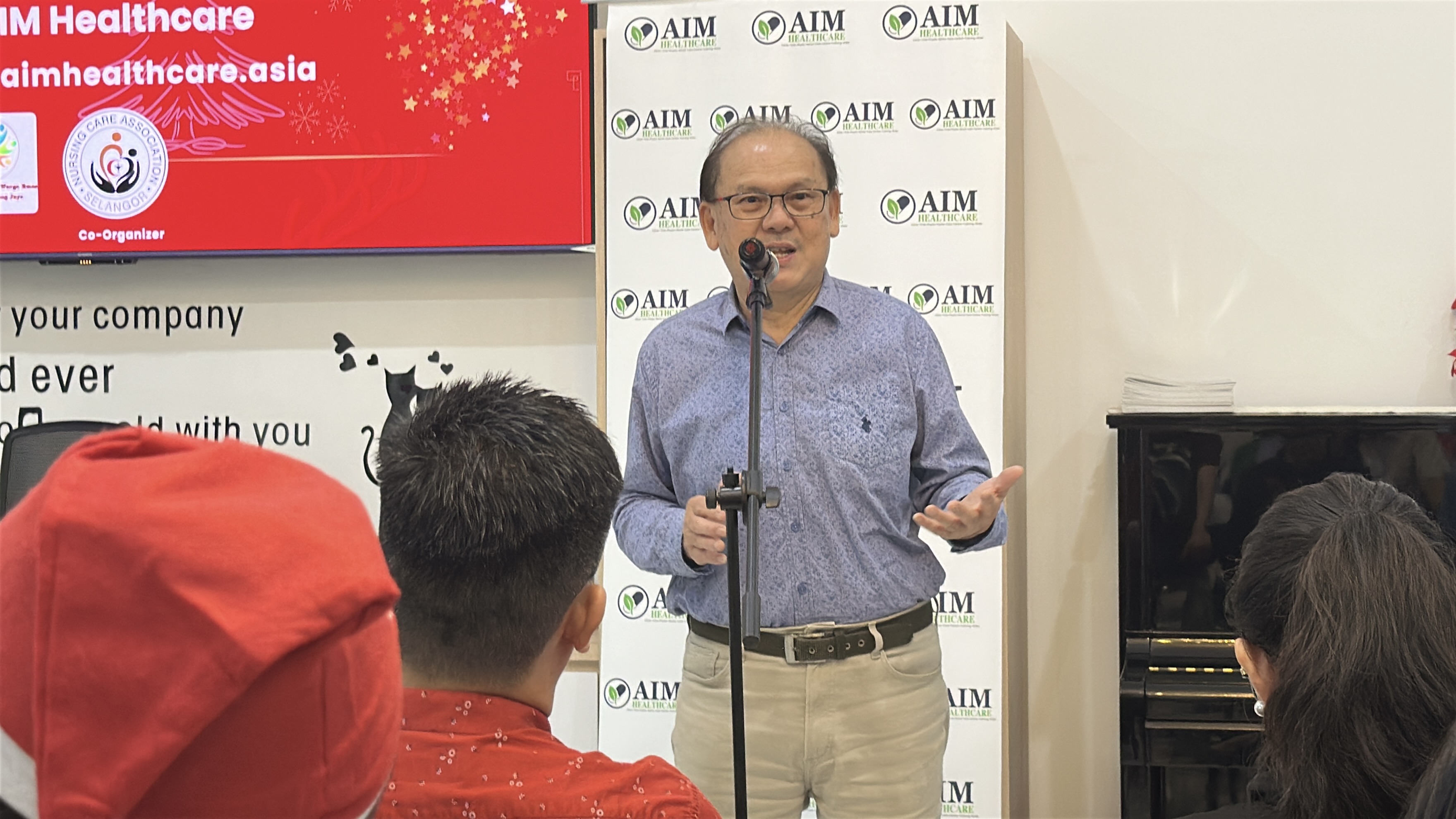 Dr. Kong Why Hong delivering welcome speech at Christmas celebration