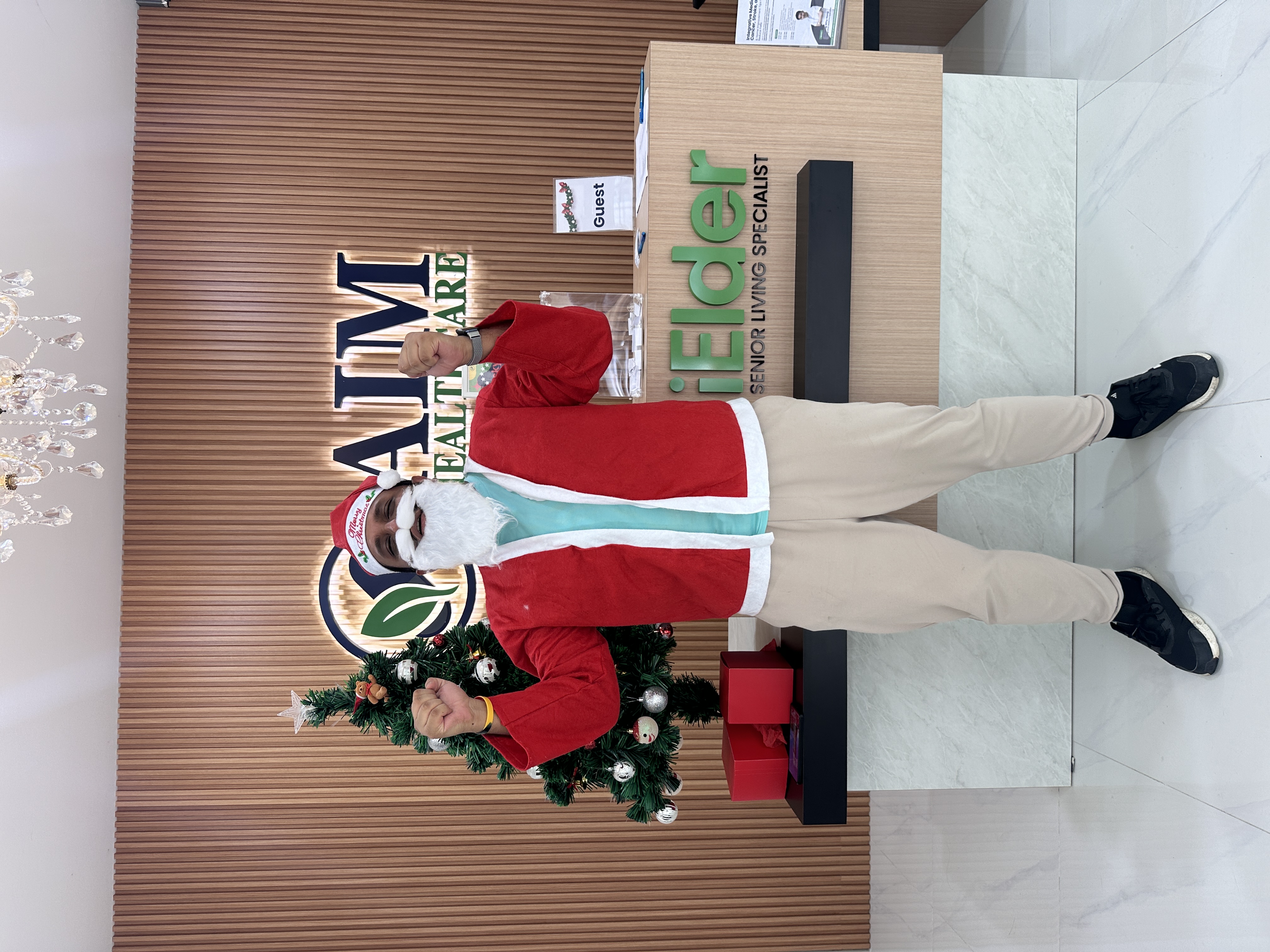 Santa Claus welcoming guests at AIM Healthcare Centre Christmas celebration